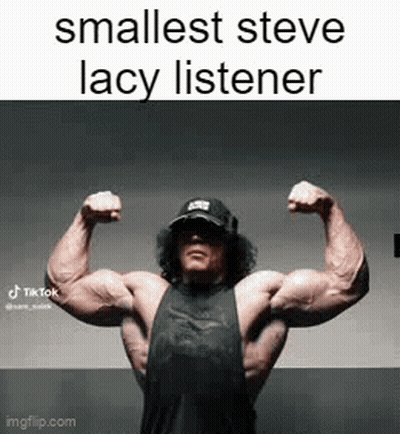 A Man Is Flexing His Muscles In A Gym . GIF
