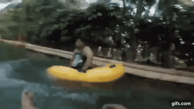 A Man Is Floating On A Yellow Raft In The Water . GIF