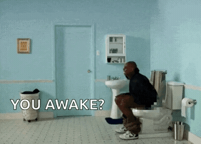 A Man Is Flying Through The Air In A Bathroom With The Words " You Awake " On The Floor GIF