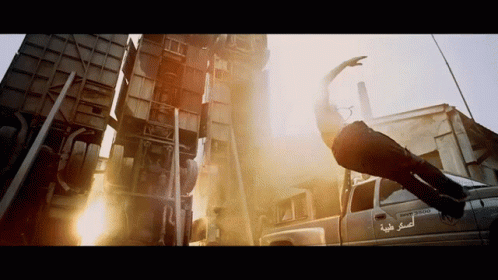 A Man Is Flying Through The Air In Front Of A Truck That Says Ram 3500 GIF