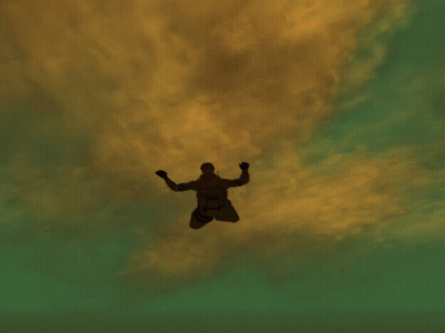A Man Is Flying Through The Air In Front Of A Very Tall Building GIF