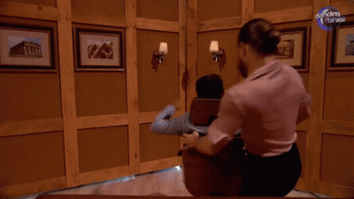 A Man Is Getting A Massage In A Room With Dancing With The Brass Written On The Bottom GIF