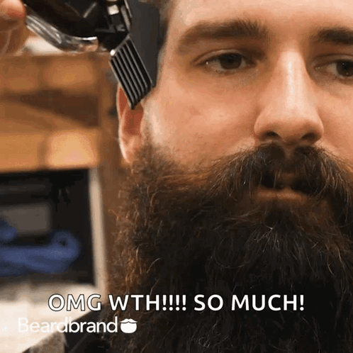 A Man Is Getting His Beard Trimmed By A Beard Brand GIF