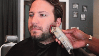 A Man Is Getting His Beard Trimmed With A Wahl Brand Clipper GIF