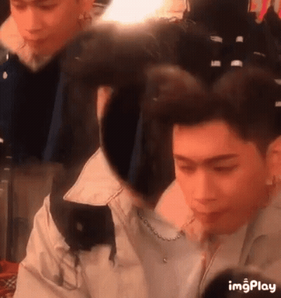 A Man Is Getting His Hair Done In A Salon While A Woman Looks On . GIF