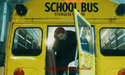 A Man Is Getting Off A Yellow School Bus With His Door Open . GIF
