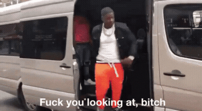 A Man Is Getting Out Of A Van With The Words Fuck You Looking At Bitch Written On The Bottom GIF