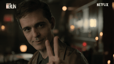 A Man Is Giving A Peace Sign In Front Of A Netflix Logo GIF