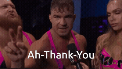 A Man Is Giving A Peace Sign While A Woman Holds A Microphone And Says " Ah-Thank-You " GIF