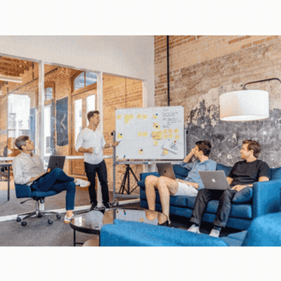 A Man Is Giving A Presentation To A Group Of People Sitting On A Couch GIF