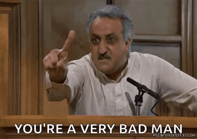 A Man Is Giving A Speech At A Podium And Pointing At The Audience . GIF