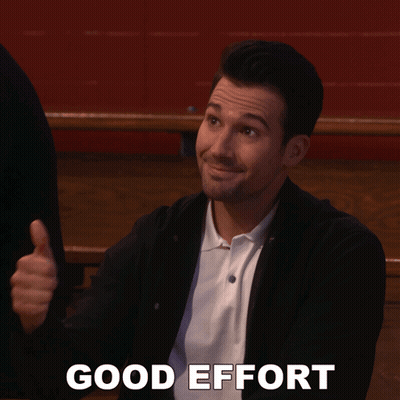 A Man Is Giving A Thumbs Up And The Words Good Effort Are Behind Him GIF