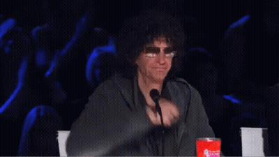 A Man Is Giving A Thumbs Up In Front Of A Microphone GIF