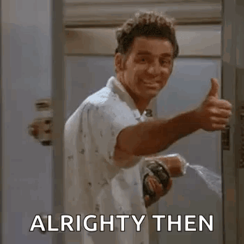 A Man Is Giving A Thumbs Up While Standing In A Doorway Holding A Spray Bottle . GIF