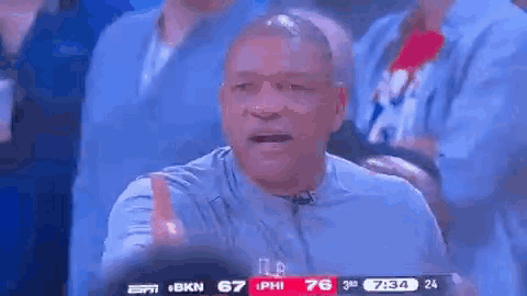 A Man Is Giving A Thumbs Up While Watching A Basketball Game On Espn . GIF