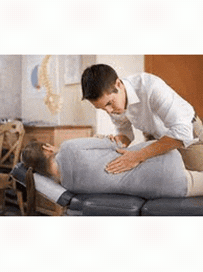 A Man Is Giving A Woman A Massage On A Table In A Room . GIF