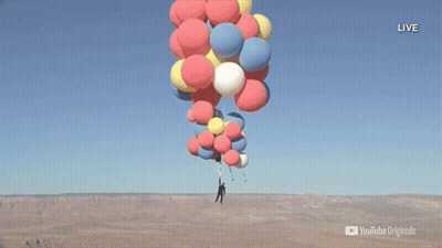 A Man Is Hanging From A Bunch Of Balloons With A Youtube Originals Logo In The Corner GIF
