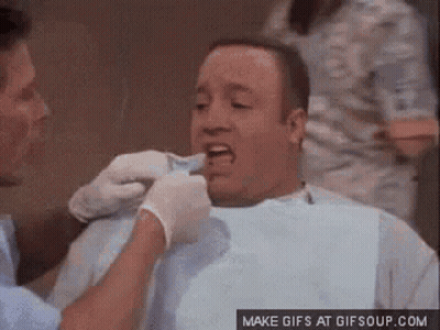 A Man Is Having His Teeth Examined By A Dentist In A Dental Chair . GIF