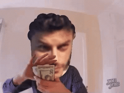 A Man Is Holding A 20 Dollar Bill In Front Of His Face .. GIF