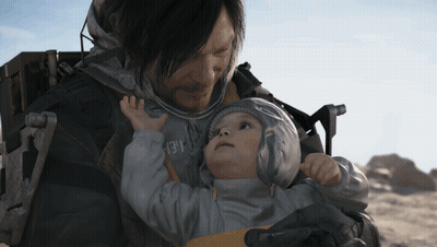 A Man Is Holding A Baby In His Arms And The Baby Is Wearing A Jacket With The Number 13 On The Front GIF