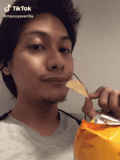 A Man Is Holding A Bag Of Chips In Front Of His Face And Says Tiktok GIF