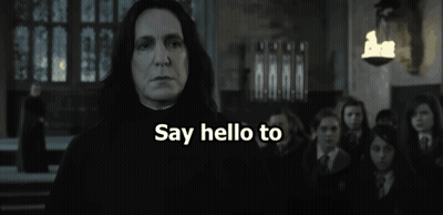 A Man Is Holding A Banana In Front Of A Group Of People And The Words Banananaa Are Visible GIF