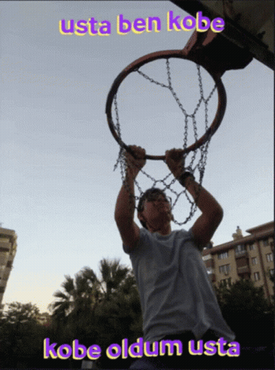 A Man Is Holding A Basketball Hoop With The Words Usta Ben Kobe Above Him GIF
