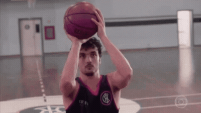 A Man Is Holding A Basketball Over His Head While Playing Basketball On A Court . GIF