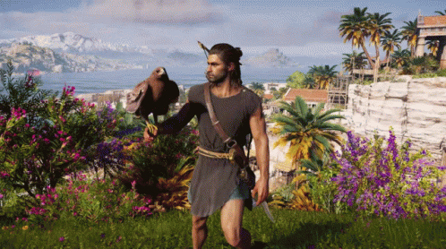 A Man Is Holding A Bird In His Hand In A Field GIF