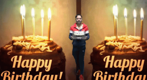 A Man Is Holding A Birthday Cake In Front Of A Happy Birthday Sign GIF