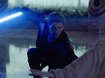 A Man Is Holding A Blue Lightsaber In His Right Hand GIF