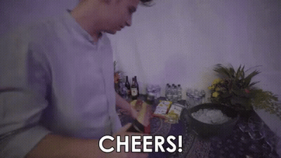A Man Is Holding A Bottle Of Champagne And Saying `` Cheers '' . GIF