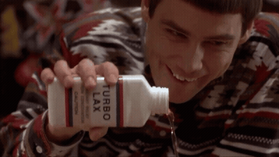 A Man Is Holding A Bottle Of Turbo Lax And Smiling GIF