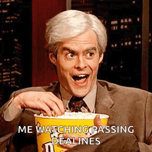 A Man Is Holding A Bucket Of M & M 'S Popcorn GIF