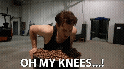 A Man Is Holding A Bucket Of Nuts With The Words Oh My Knees Written Below Him GIF