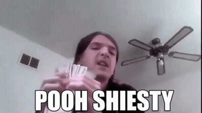 A Man Is Holding A Bunch Of Money And A Ceiling Fan In His Hands . GIF