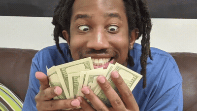 A Man Is Holding A Bunch Of Money In His Hands GIF