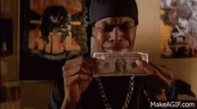 A Man Is Holding A Bunch Of Money In His Hands . GIF