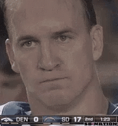 A Man Is Holding A Can Of Soda In Front Of His Face During A Game . GIF