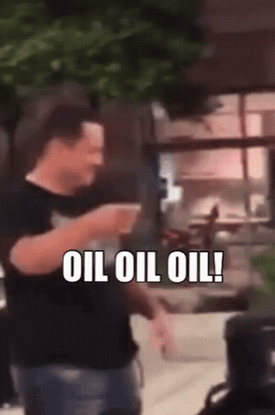 A Man Is Holding A Cup Of Coffee And Saying Oil Oil Oil GIF