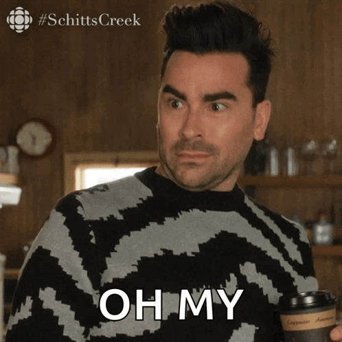 A Man Is Holding A Cup Of Coffee And Says " Oh My " GIF