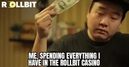 A Man Is Holding A Dollar Bill In His Hand And Saying `` Me Spending Everything I Have In The Roll Bit Casino '' . GIF