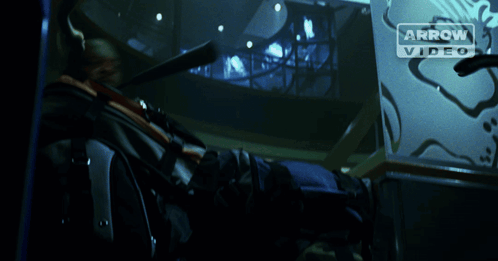 A Man Is Holding A Fire Extinguisher In Front Of An Arrow Video Logo GIF