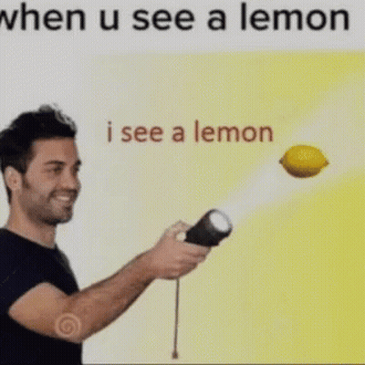 A Man Is Holding A Flashlight And A Lemon Is Flying In The Air Behind Him . GIF