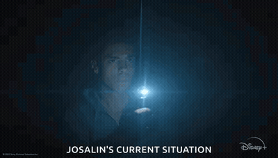 A Man Is Holding A Flashlight In The Dark And Looking At It . GIF