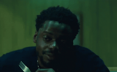A Man Is Holding A Fork In His Hand And Saying `` Damn '' While Eating . GIF
