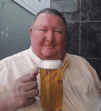 A Man Is Holding A Glass Of Beer That Says Kon GIF