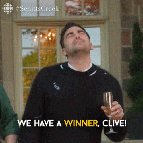 A Man Is Holding A Glass Of Wine And Saying We Have A Winner , Clive . GIF