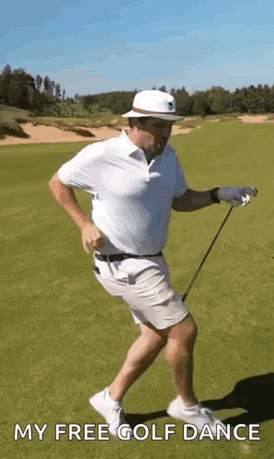 A Man Is Holding A Golf Club And Dancing On A Golf Course . GIF