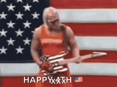 A Man Is Holding A Guitar In Front Of An American Flag . GIF